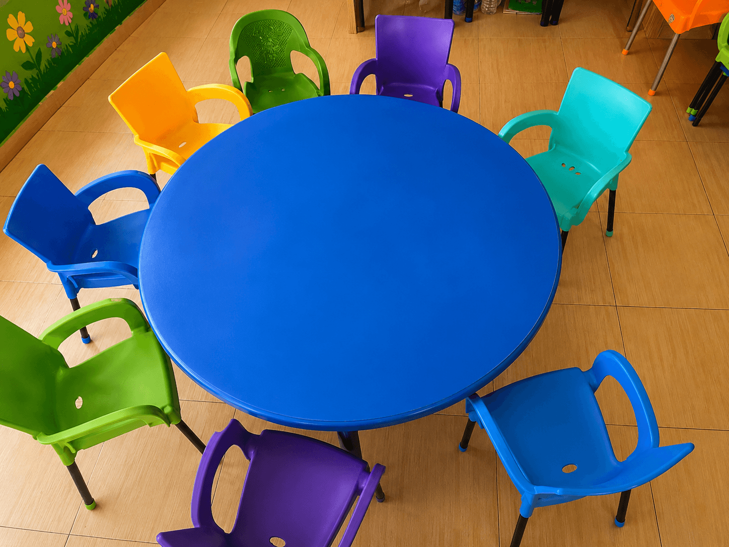 Round classroom table with colourful chairs